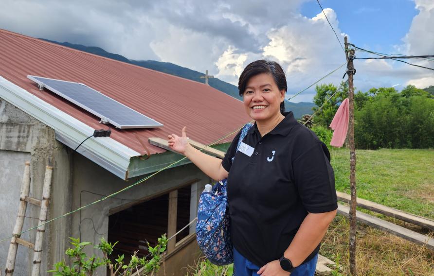 Jacobs team member shows off a solar panel