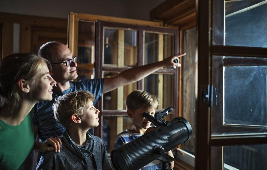 Family using a telescope