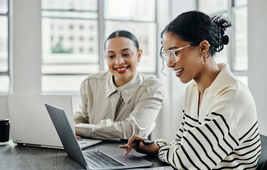 Two women looking at a laptop