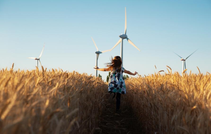 Girl running through a wheat field