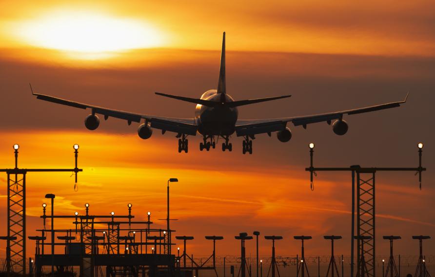Plane in the sunset sky