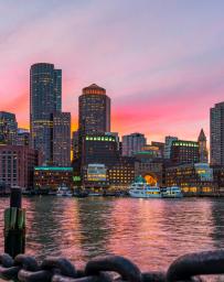 Boston skyline and Fort Point Channel at sunset as viewed fantastic twilight or dusk time from Fan Pier Park in Boston, Massachusetts, USA. United state downtown beautiful colorful skyline.