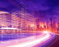 time lapse image of traffic on a highway with cityscape in background