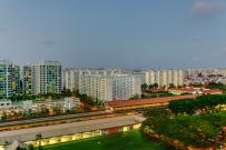 High density residential housing towers next to mass rapid transit train line in Singapore