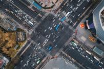 Aerial view of busy city intersection with traffic moving in both directions