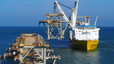 Ship lifting one of the modules into place during construction of the new wharf