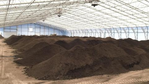 Compost in piles at facility