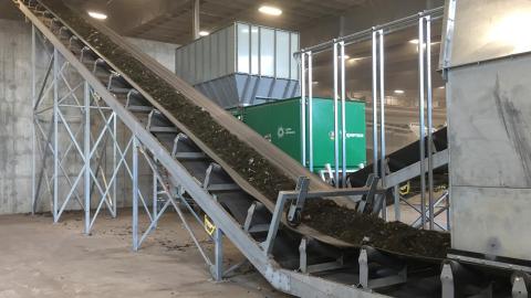 Compost on conveyor