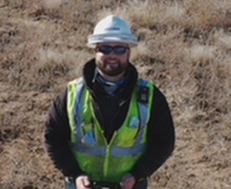 Drone pilot in hard hat and hi vis vest