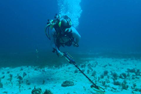 Jacobs diver uses metal detector underwater