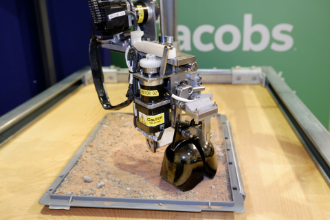 Jacobs robot digs in a small plot of sand
