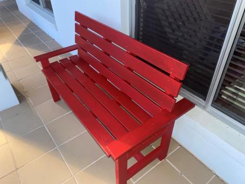 Red two-seater garden bench