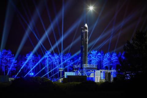 Orbex Prime rocket at night with blue lights