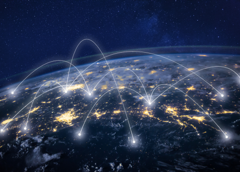 Aerial view of Earth with lit up connection points, symbolizing a connected world