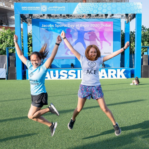 Two young women jump in air