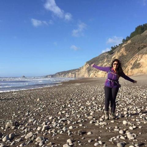 Mala Alahmadi hiking on a beach