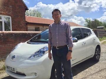 Graeme Cooper poses with an EV
