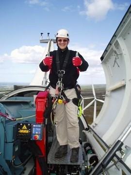 Graeme Cooper poses atop a wind turbine