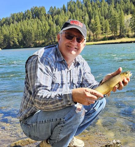 Loren catching (and releasing) a beautiful trout while camping and fishing with his family at the nearby Snake River
