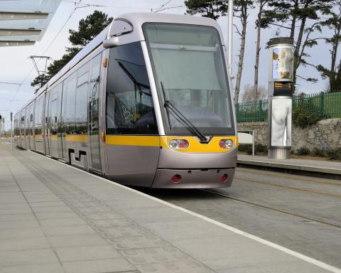 Silver and yellow tram at station