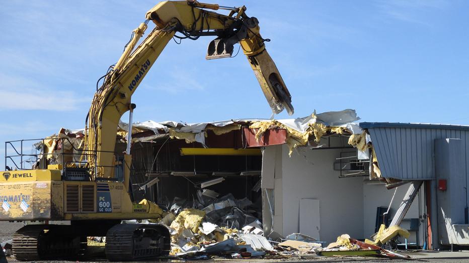 Crane demolishes a building