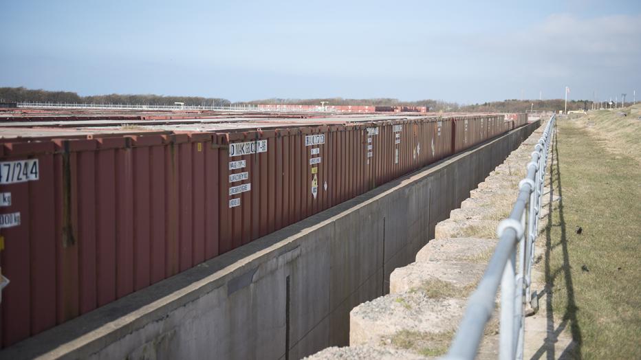 Waste in metal shipping containers lined up outside