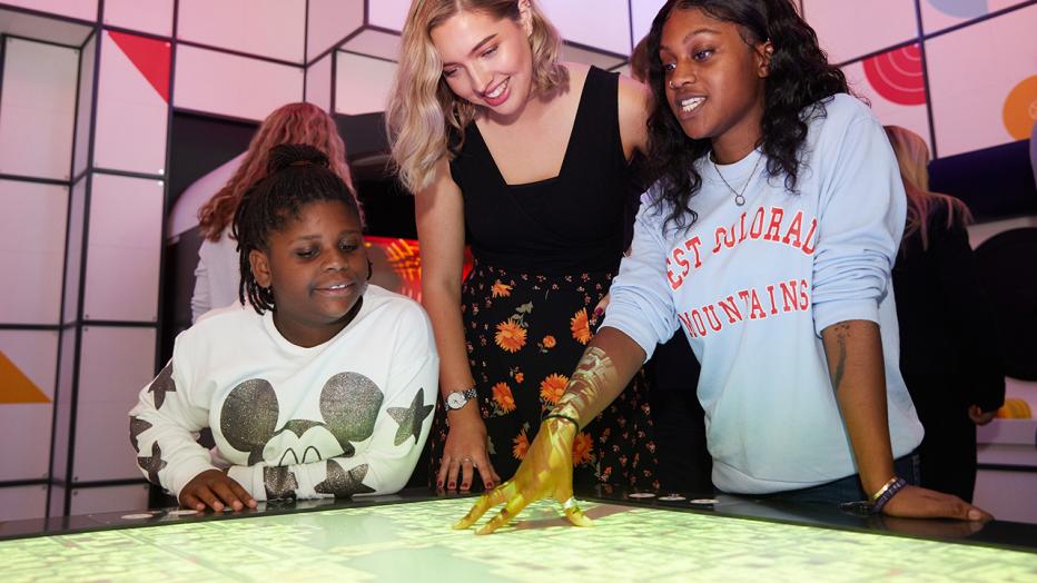 STEAM education with blond woman flanked by two young Black girls