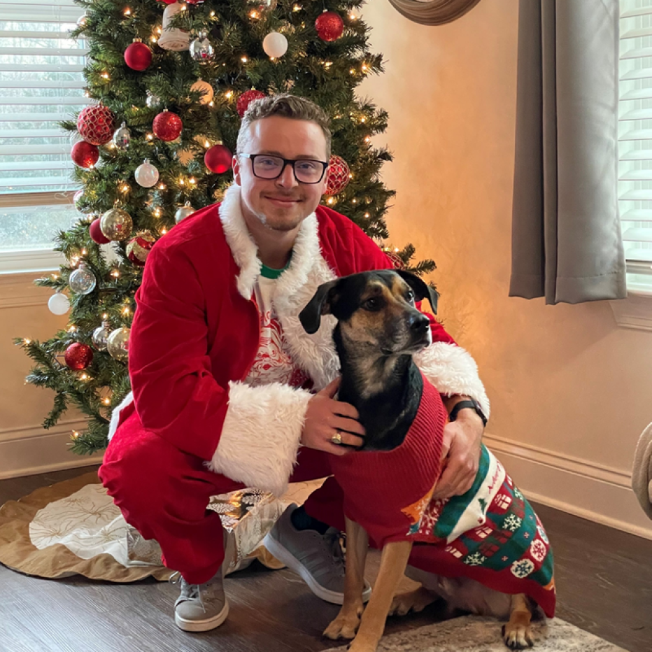 Avery and Smoky the dog by the Christmas tree