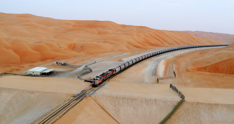 Etihad Rail - train driving between gorgeous orange sand dunes