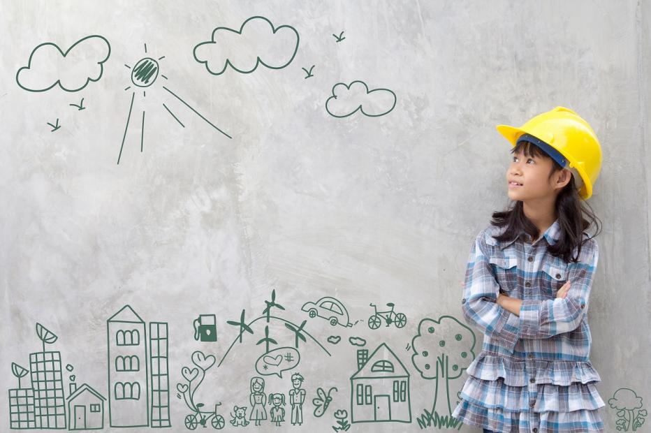 Young girl in a yellow hard hat in front of a green sketch of city and transportation