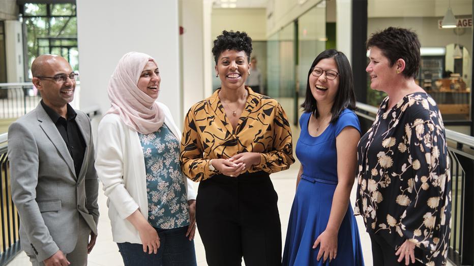 Four women and a man in a group shot