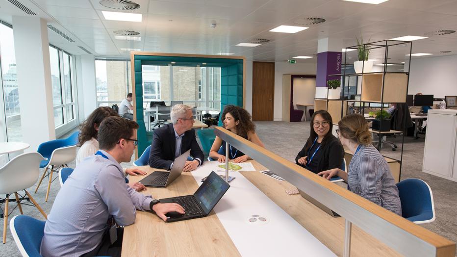 People collaborating around a table in the Jacobs London office