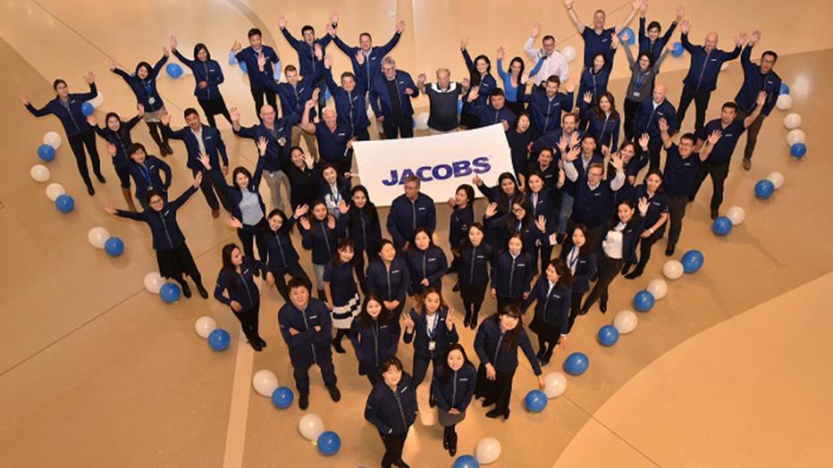 Jacobs employees standing in shape of heart