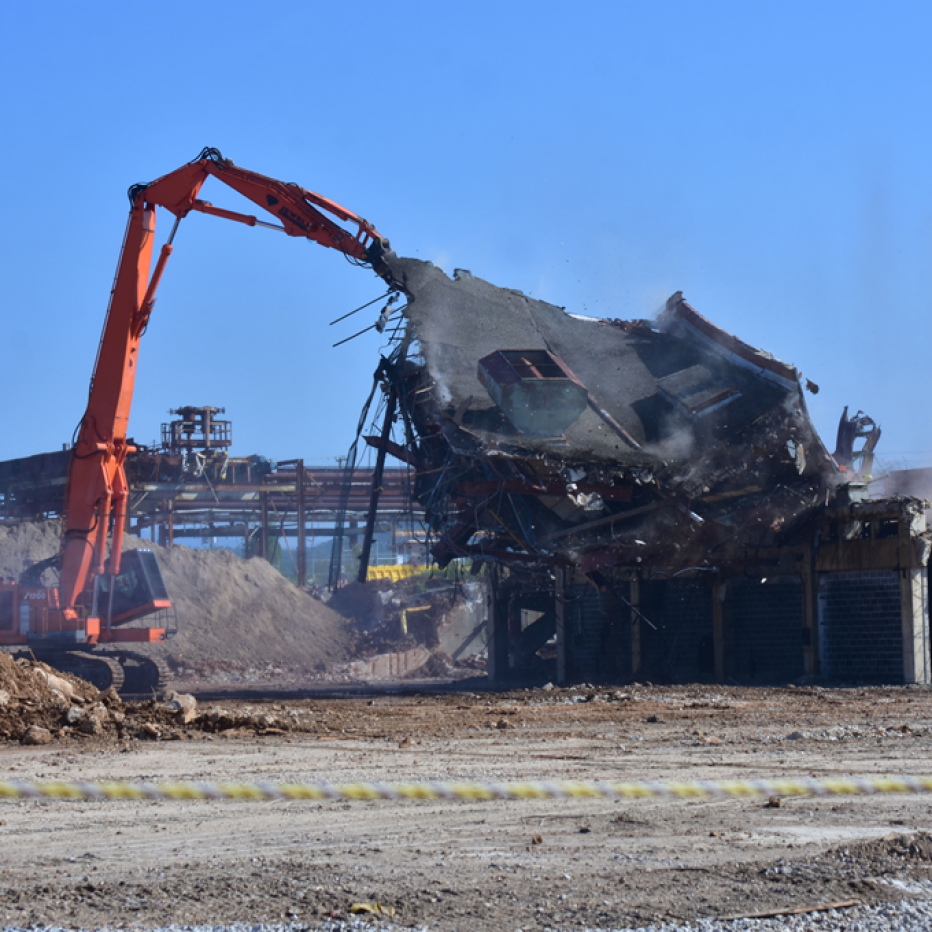 Crane demolishing wall