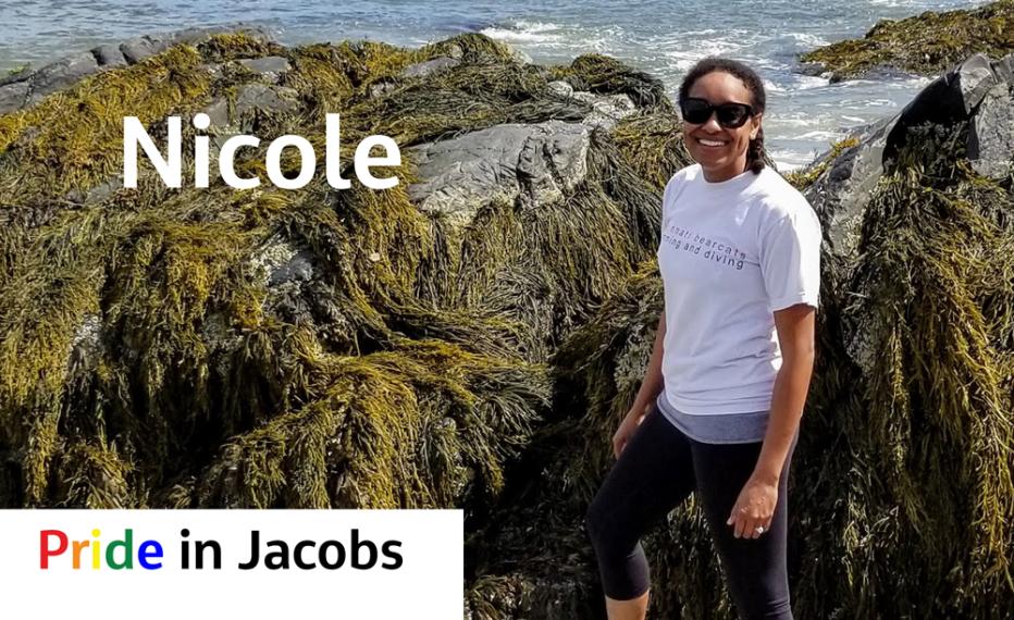 Nicole standing by rocks at the shore