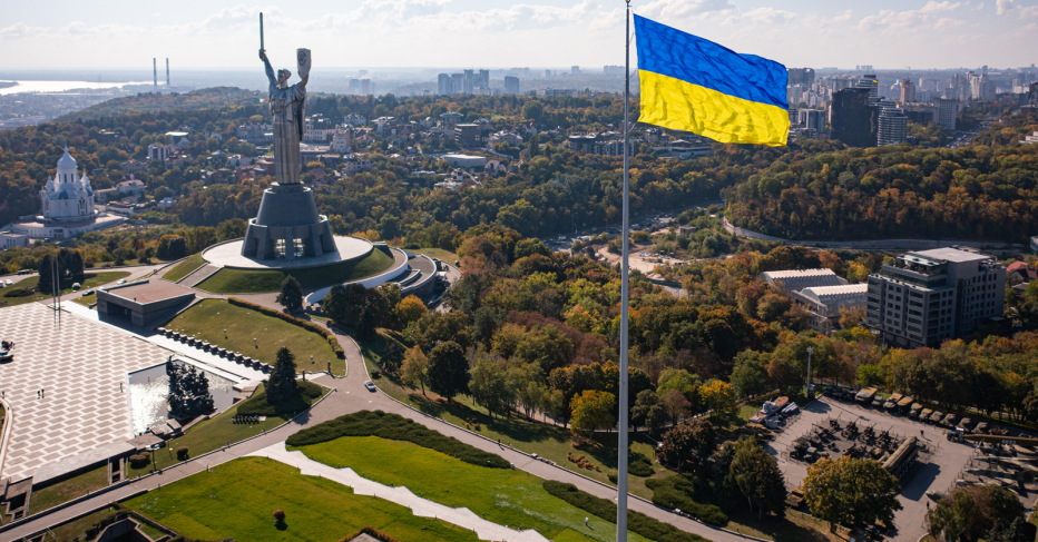 Ukraine flag flying over the city in the background