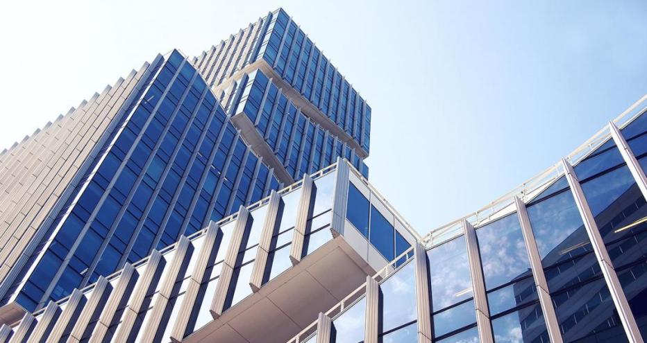 Stock image of skyscrapers with glass windows top to bottom