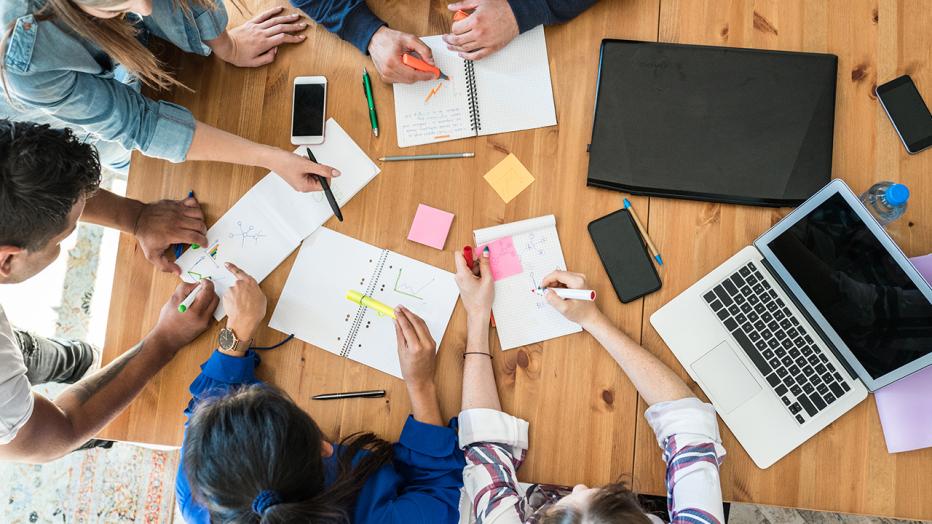 Aerial view of people collaborating on a desk