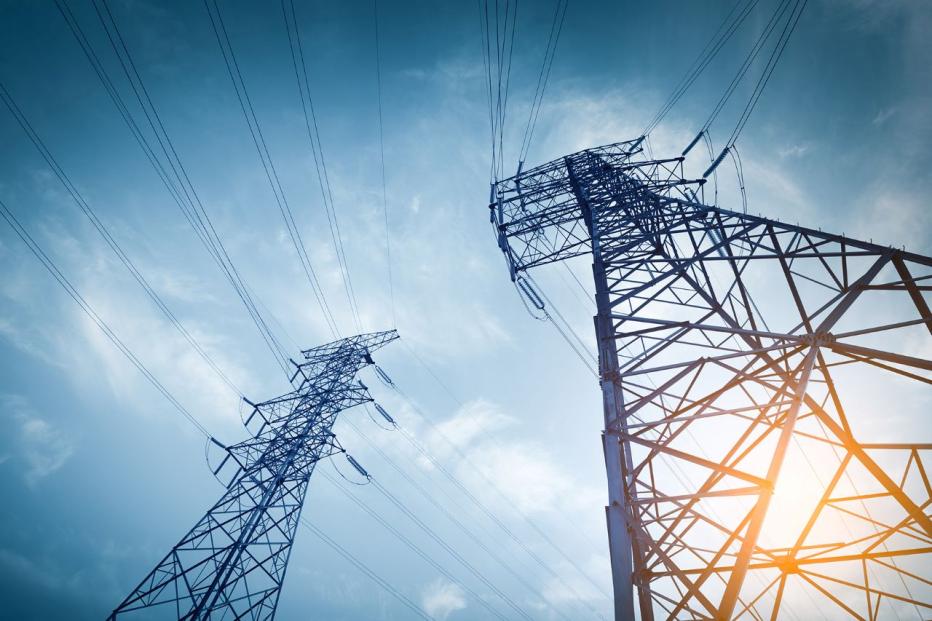 looking upwards from the base of 2 electric pylons