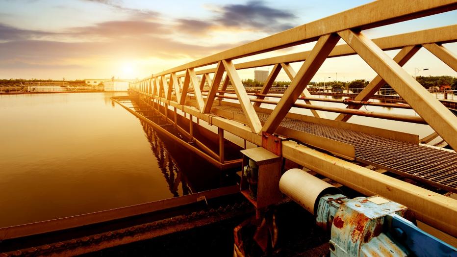 Wastewater infrastructure at sunset over water