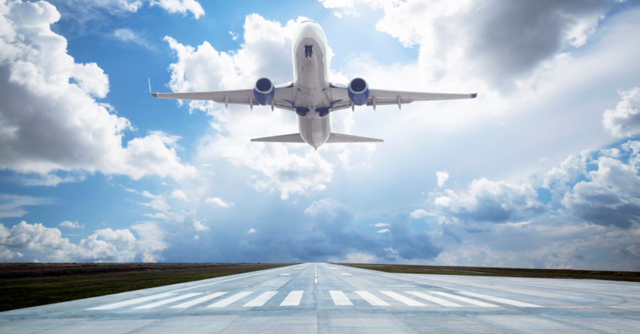 Airplane taking off on runway into blue skies