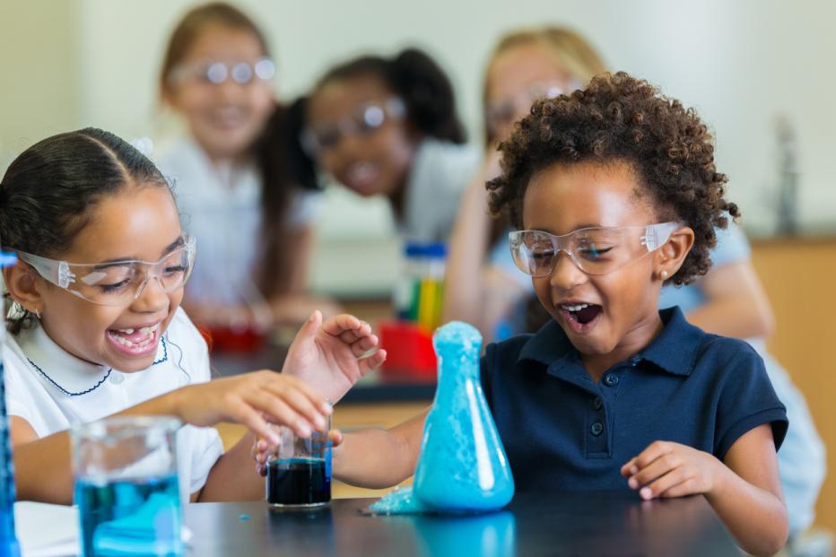 Young verse girl children doing a science experiment