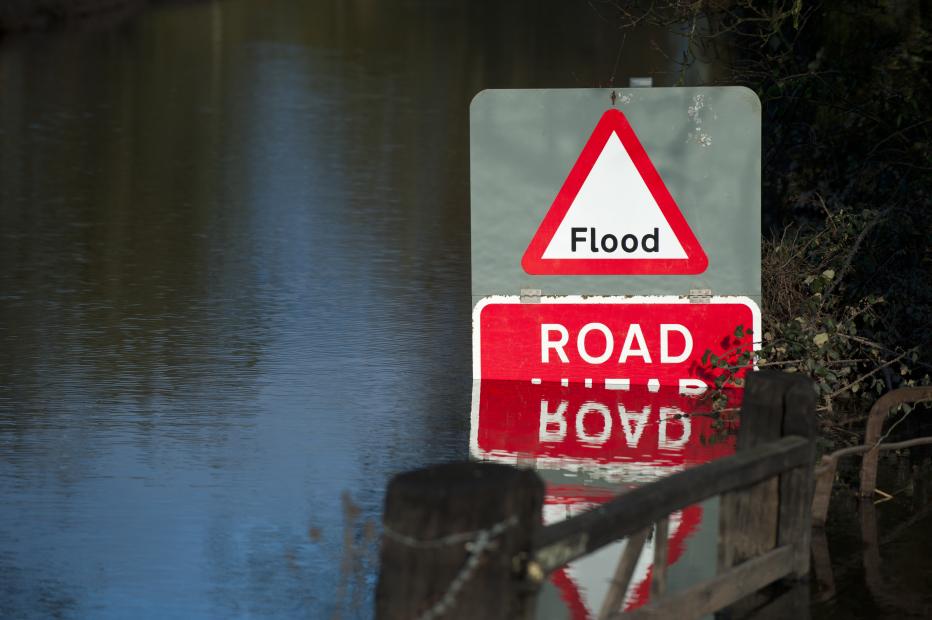 Flooded road with red "Flood" sign