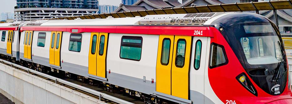 Red and yellow mass transit train elevated in front of skyscrapers