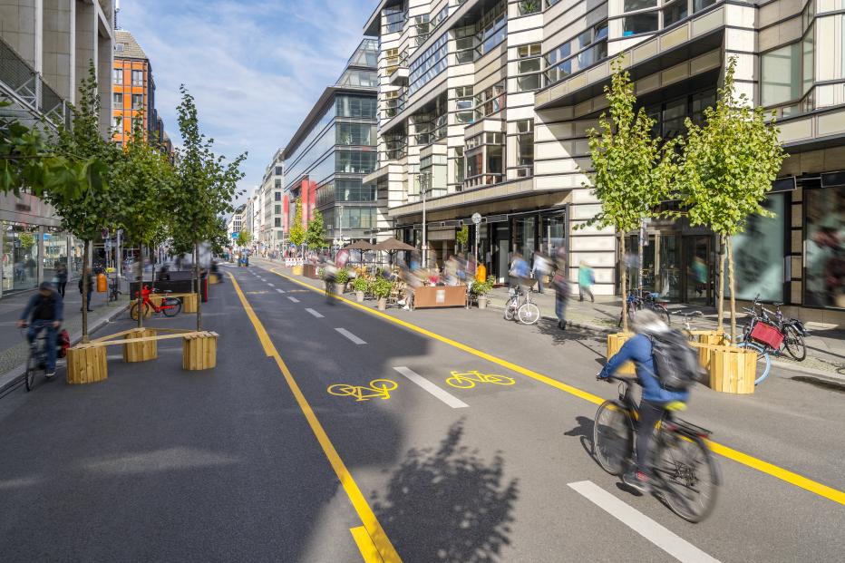 Pop-up bicycle lane in central Berlin with people biking, walking and relaxing. This is a trial concept for urban planning which improves the quality of life of people.