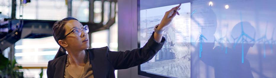 Woman pointing at a digital dashboard
