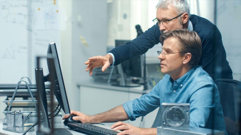 Two people looking at a computer screen