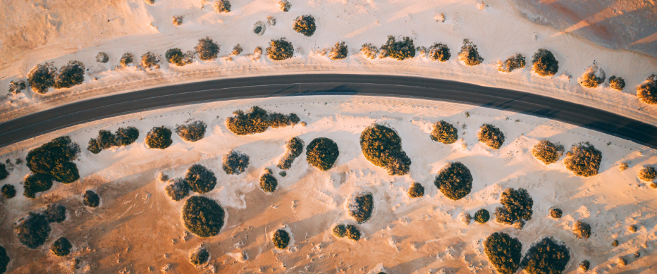 Birds eye view of a road running through a desert landscape