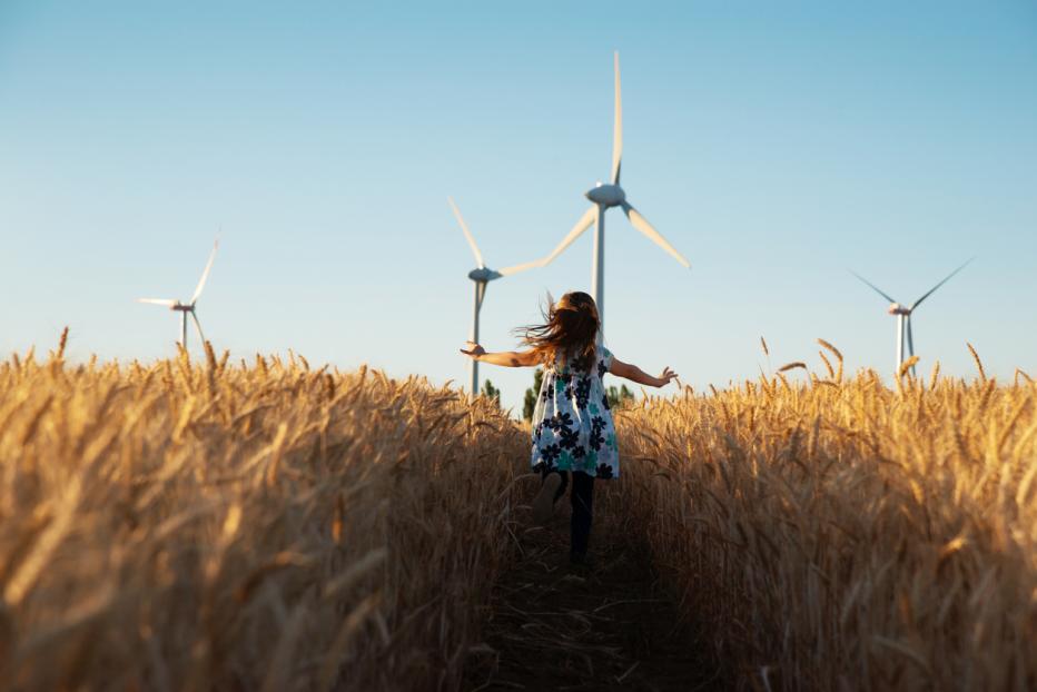 Girl running through a wheat field