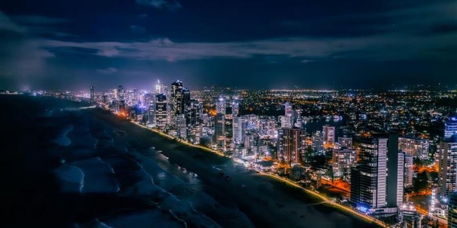 A nighttime aerial view of Gold Coast Australia with a brightly lit skyline